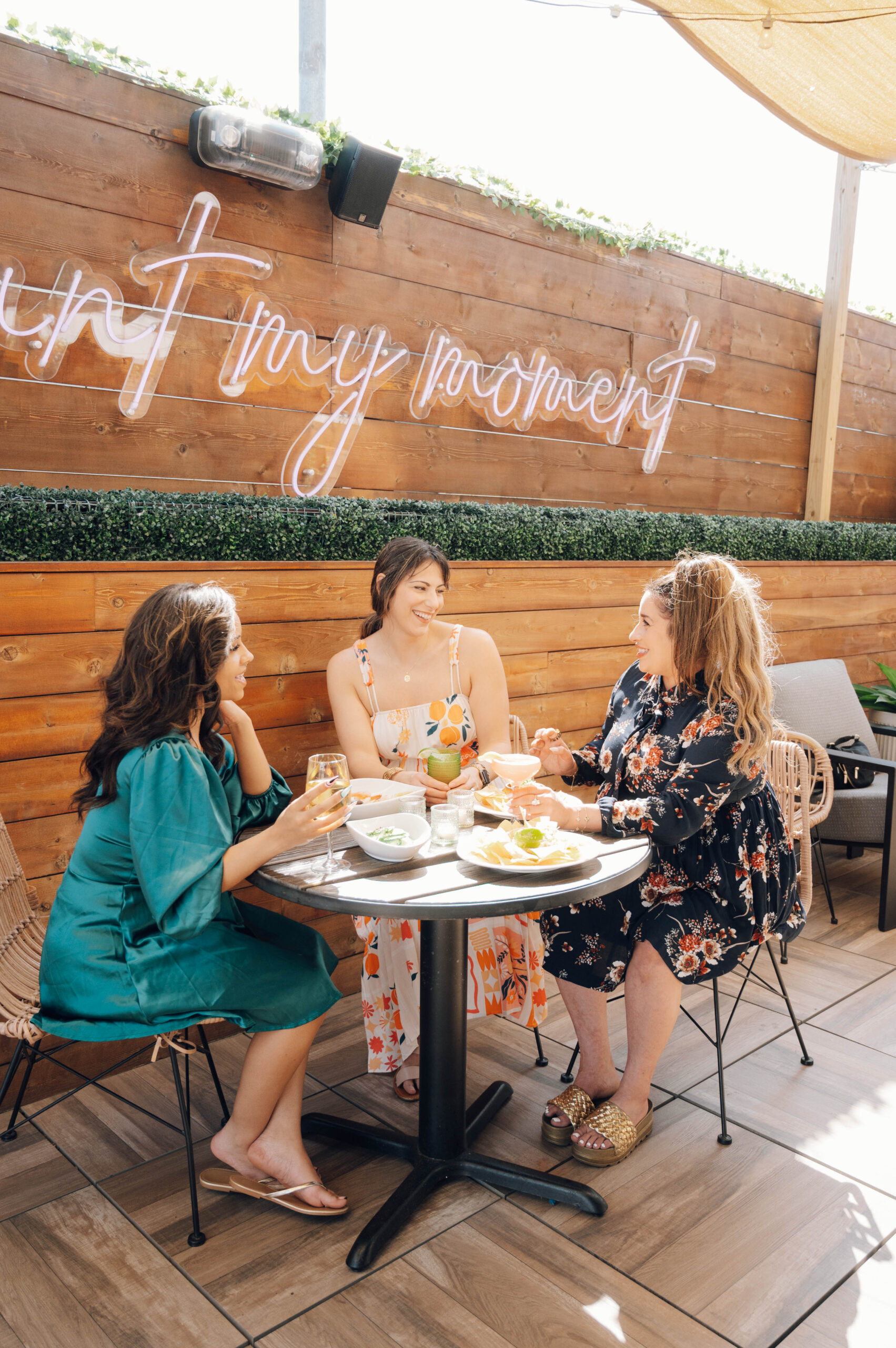 Ladies sitting at a table on AVA rooftop bar having cocktails
